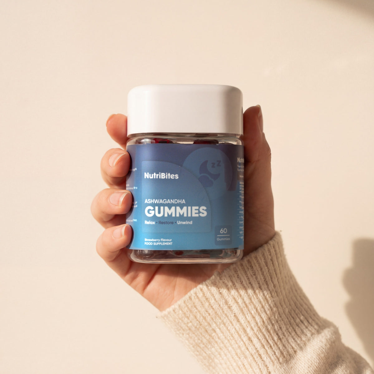 NutriBites Ashwagandha Gummies, strawberry flavour: jar held in a hand
