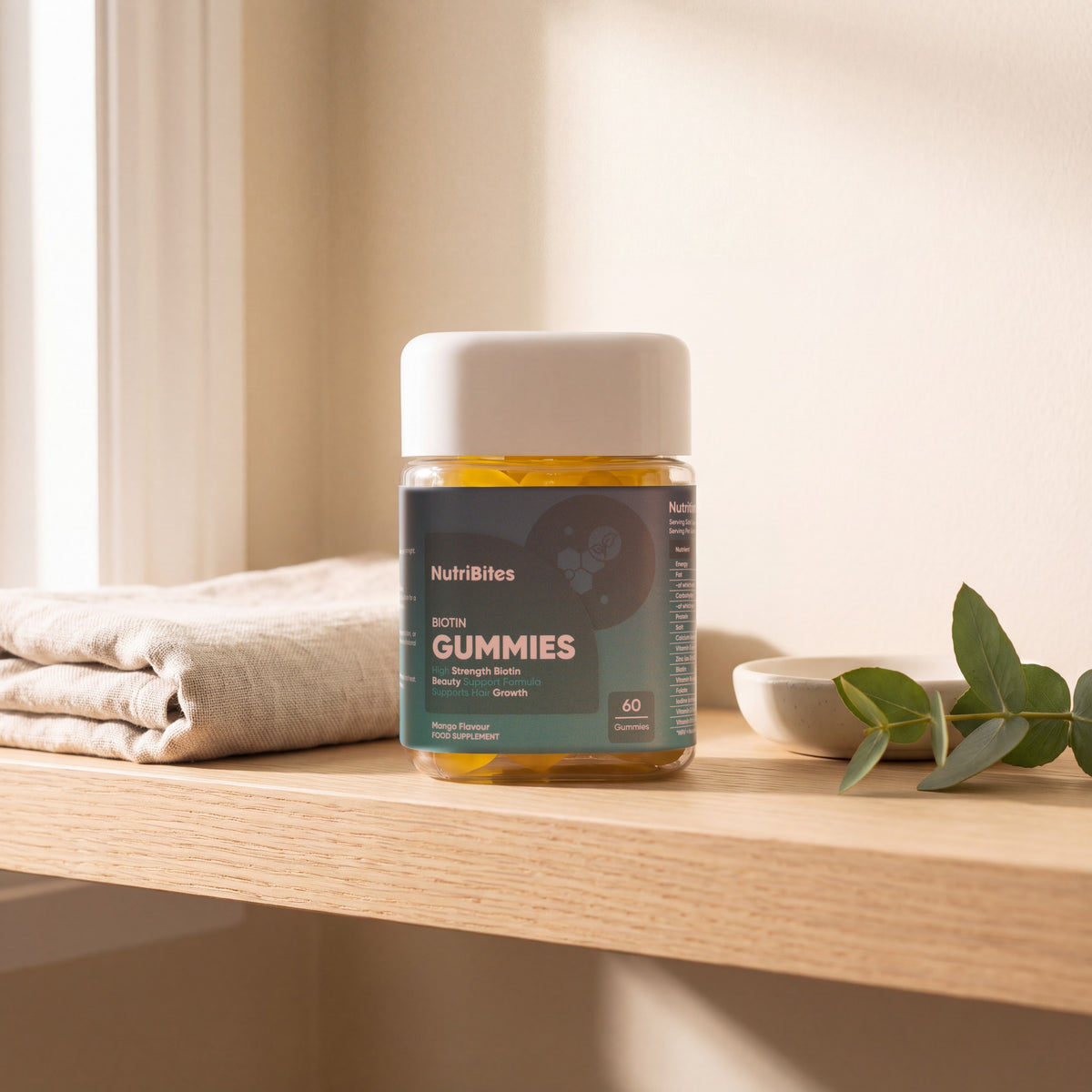 NutriBites Biotin Gummies, mango flavour: jar in an everyday setting