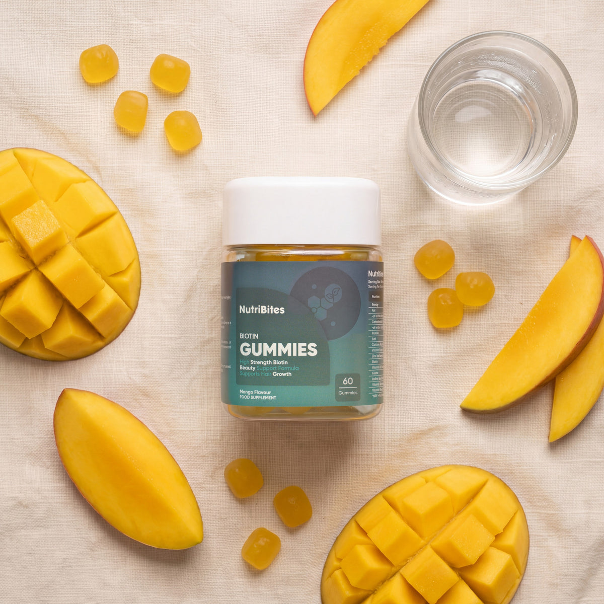 NutriBites Biotin Gummies, mango flavour: flat-lay of the jar with loose gummies