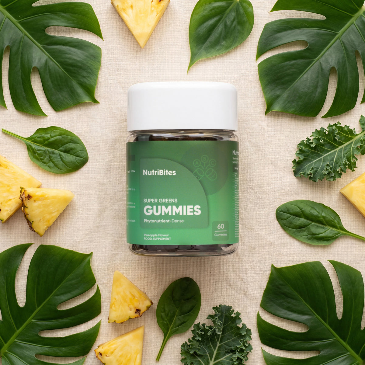 NutriBites Super Greens Gummies, pineapple flavour: flat-lay of the jar with loose gummies